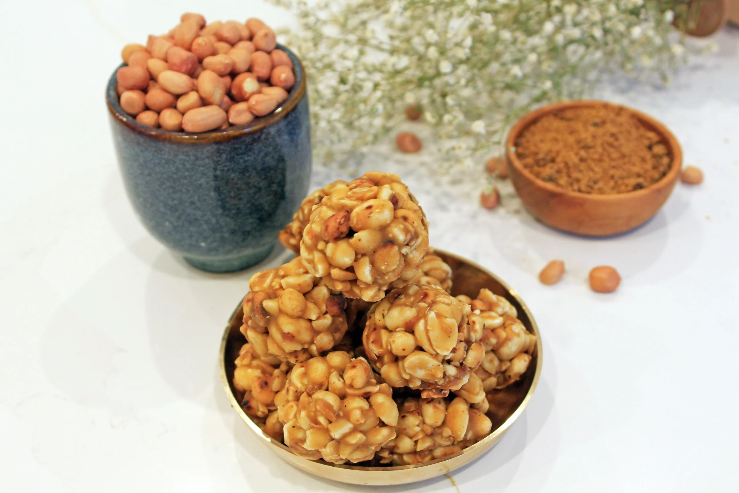 A close-up of Peanut Ladoo by Reddot Food, displaying its round shape and textured surface with roasted peanuts, showcasing the sweet and crunchy nature of this traditional Indian treat.