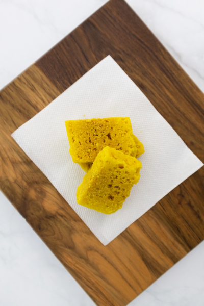 A close-up of Mysore Pak, a classic South Indian sweet by Reddot Food, showcasing its rich, crumbly texture and golden-brown color, highlighting its luxurious flavor.