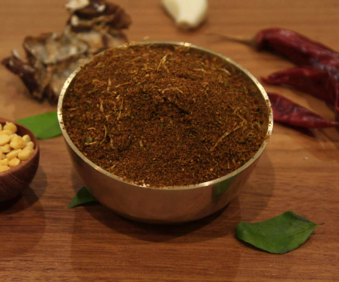 A close-up of Gun Powder, a traditional South Indian spicy podi by Reddot Food, featuring a vibrant mix of ground lentils and spices.