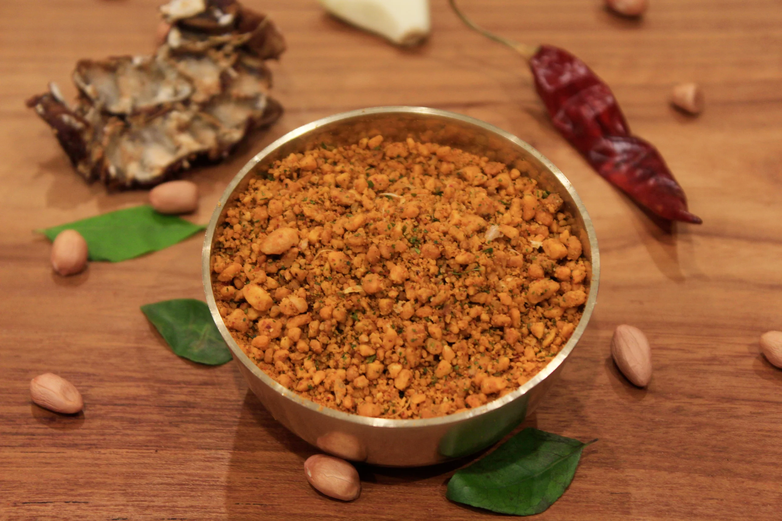 A close-up of Peanut Podi, a spicy and nutty Indian condiment by Reddot Food, made with ground peanuts and spices, perfect for enhancing the flavor of rice and other dishes.