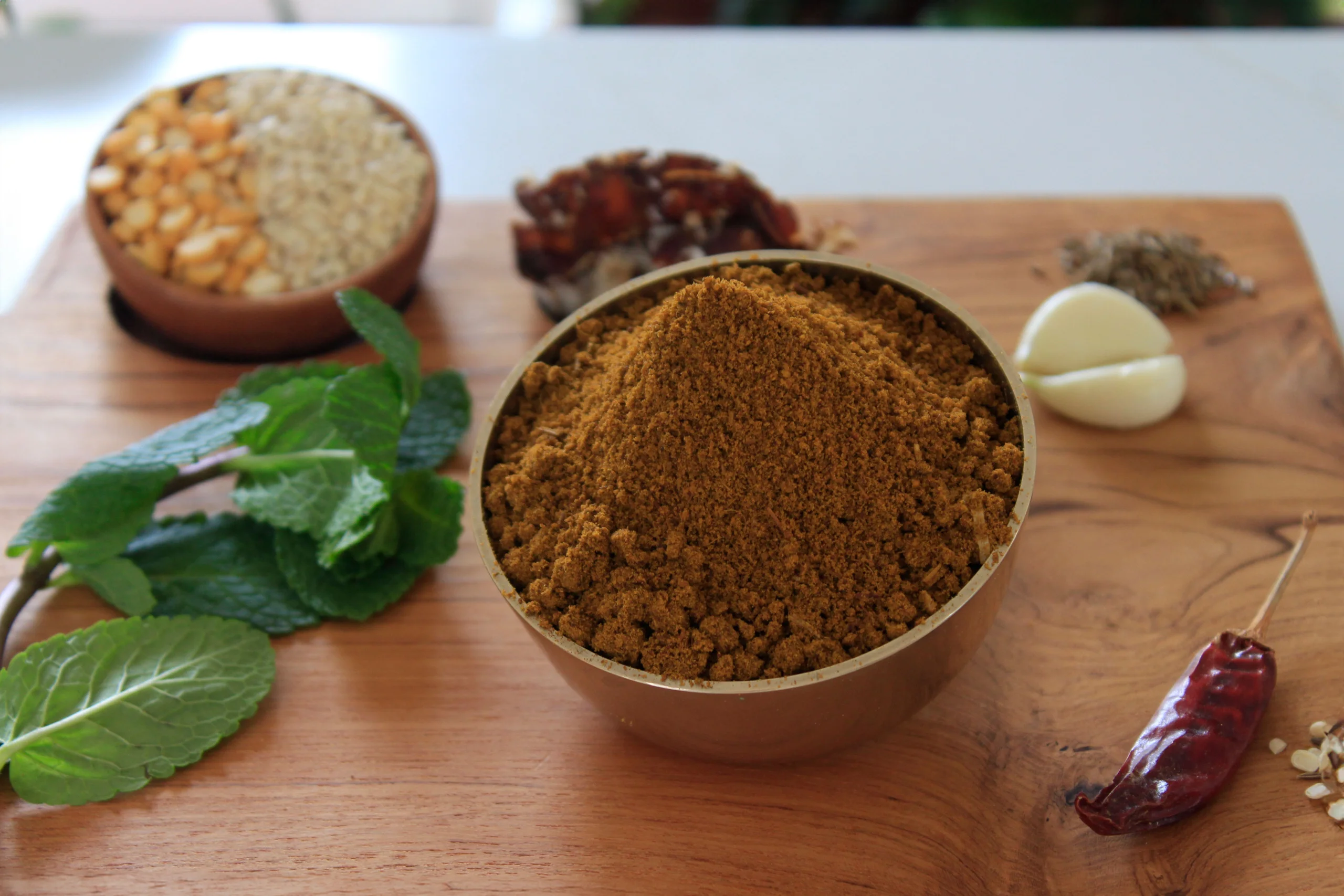 A close-up of Mint Leaf Podi, a vibrant and aromatic Indian condiment by Reddot Food, made with dried mint leaves and spices, perfect for enhancing rice and other dishes.