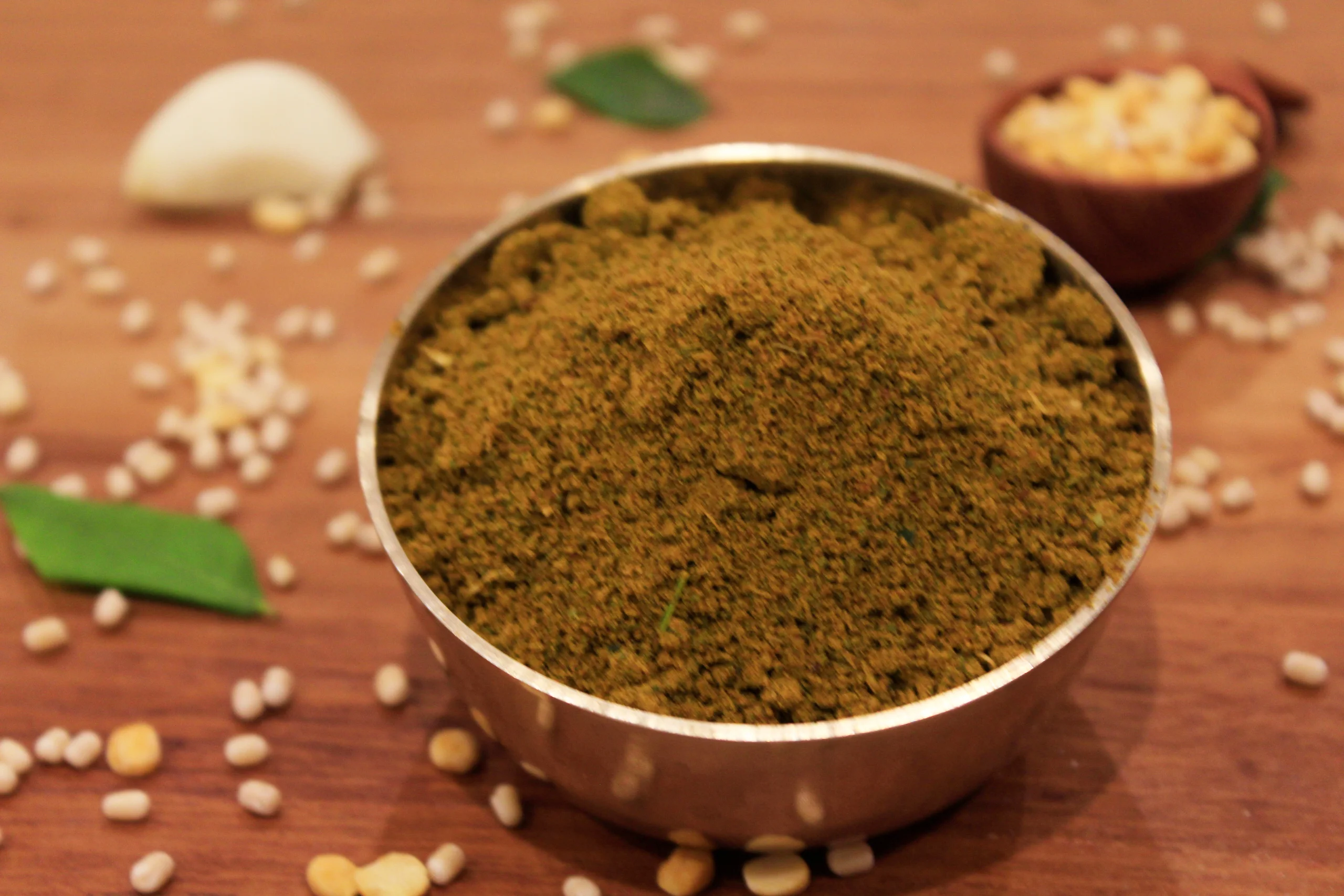 A close-up of Curry Leaf Podi, a savory spice blend made with fresh curry leaves and spices by Reddot Food, ideal for enhancing the flavor of rice and other dishes.