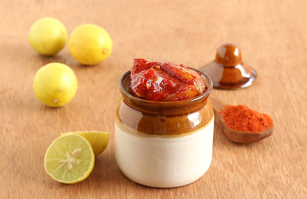 A vibrant Lemon Pickle from Reddot Food, showcasing tangy lemon pieces in a spicy, flavorful sauce.