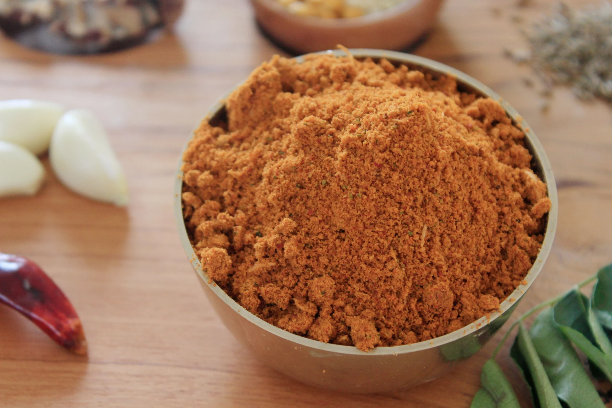 A close-up of Idli Podi, a South Indian spice mix with urad dal and curry leaves, enhancing the savory aroma of steamed idlis.