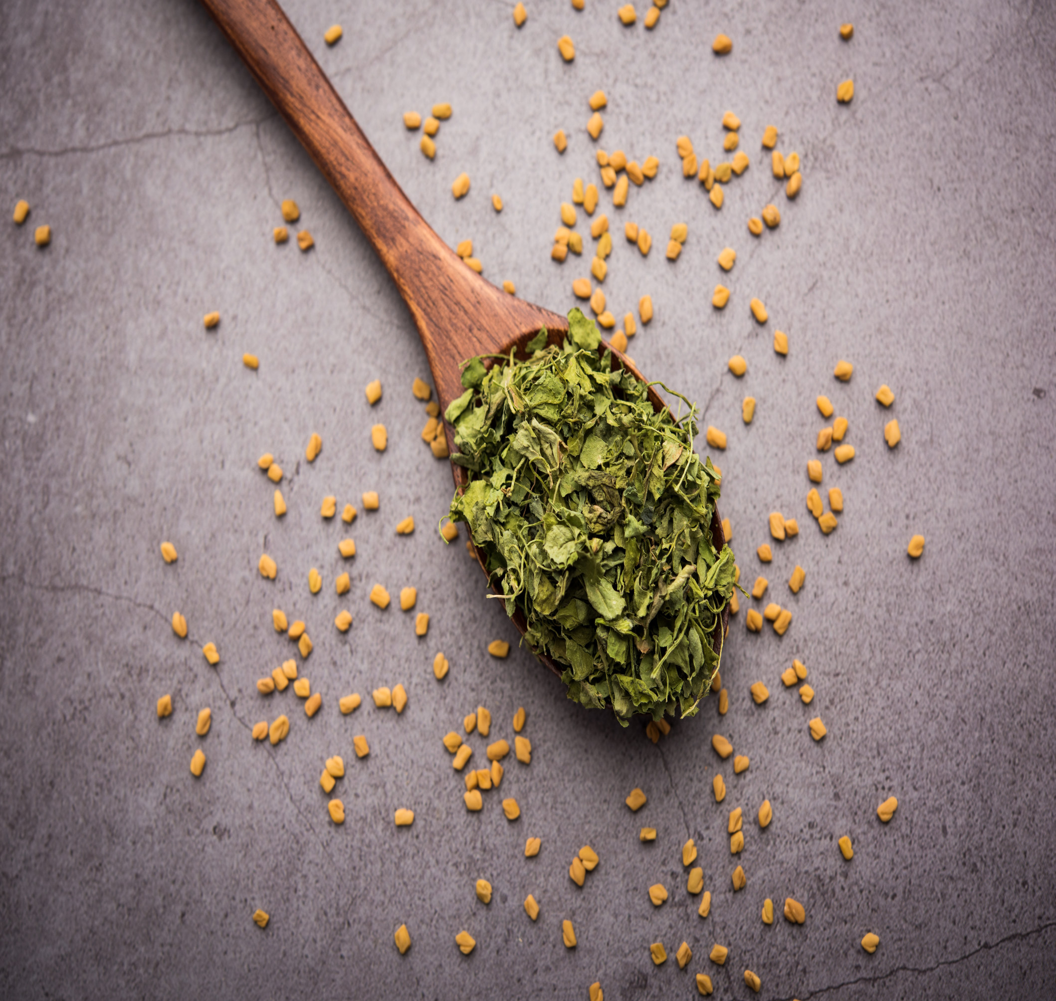 Kasuri Methi, dried fenugreek leaves, used to add a distinctive aroma and flavor to Indian dishes, showcasing its vibrant green color.