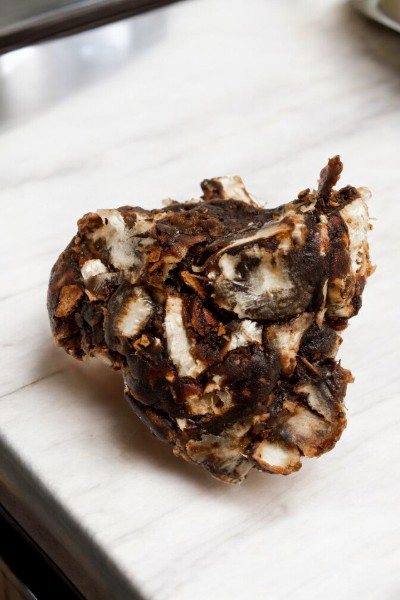 Close-up of seedless tamarind, dark brown in color and sticky texture, ideal for adding a tangy twist to curries, chutneys, and sauces.