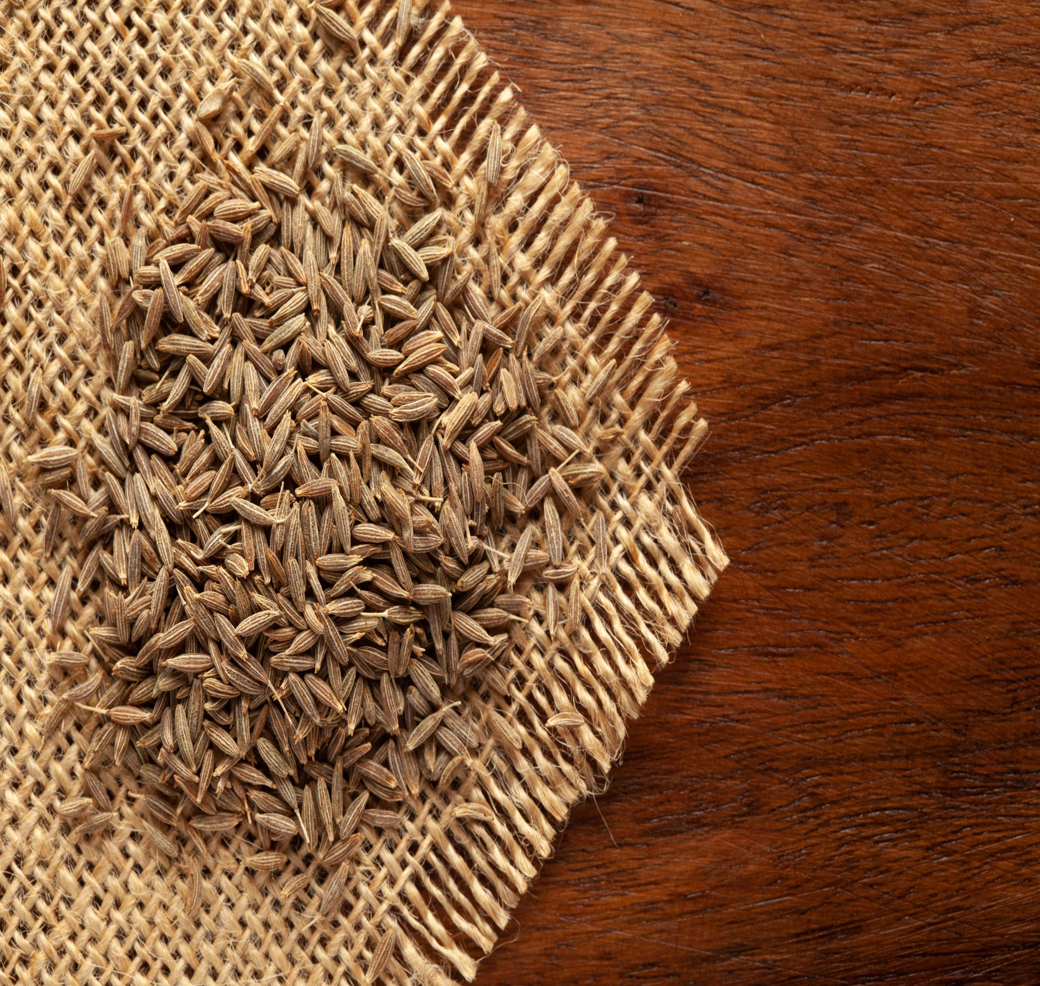 A close-up of cumin seeds, a staple spice in Indian cuisine, known for its warm, earthy flavor and aromatic fragrance.