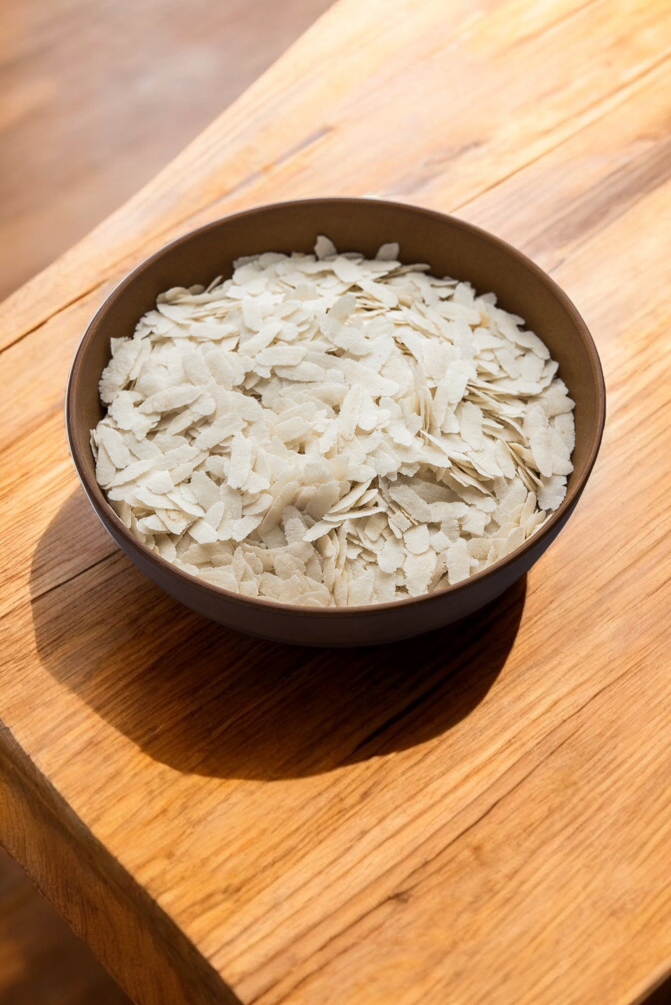 Close-up of medium-sized Poha (flattened rice), light and flaky, perfect for making quick and nutritious Indian breakfast dishes like poha or upma.